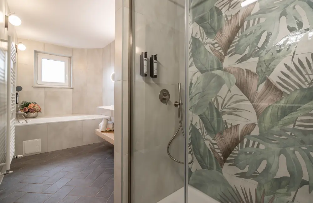 Bathroom with shower and bathtub in the Tara Deluxe Suite, Villa Bellevue Portorož